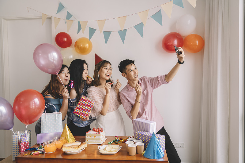 一群朋友为一位华裔女性同事庆祝生日图片素材