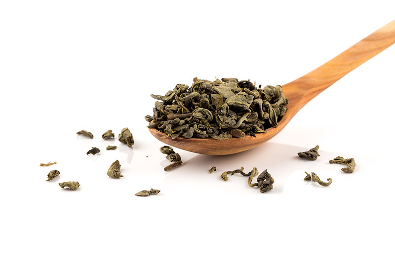 中国火药绿茶在勺子孤立在白色的背景图片下载