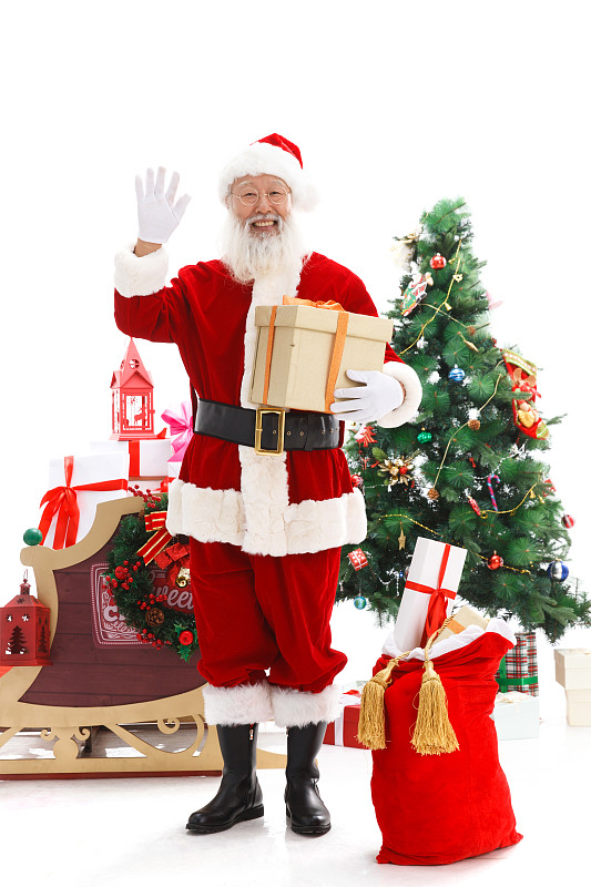 一个圣诞老人正在抱着圣诞礼物图片下载