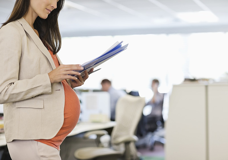 怀孕的女商人在办公室工作图片素材