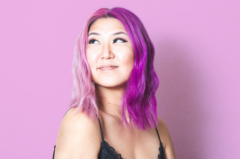 粉色和紫色的头发映衬着相配的粉色背景图片素材