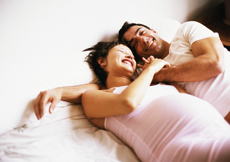男人和孕妇并排躺在床上图片下载