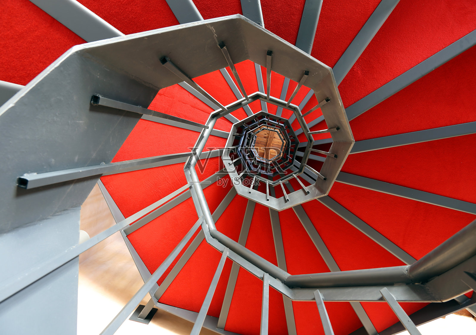 现代建筑中的螺旋楼梯和红地毯照片摄影图片