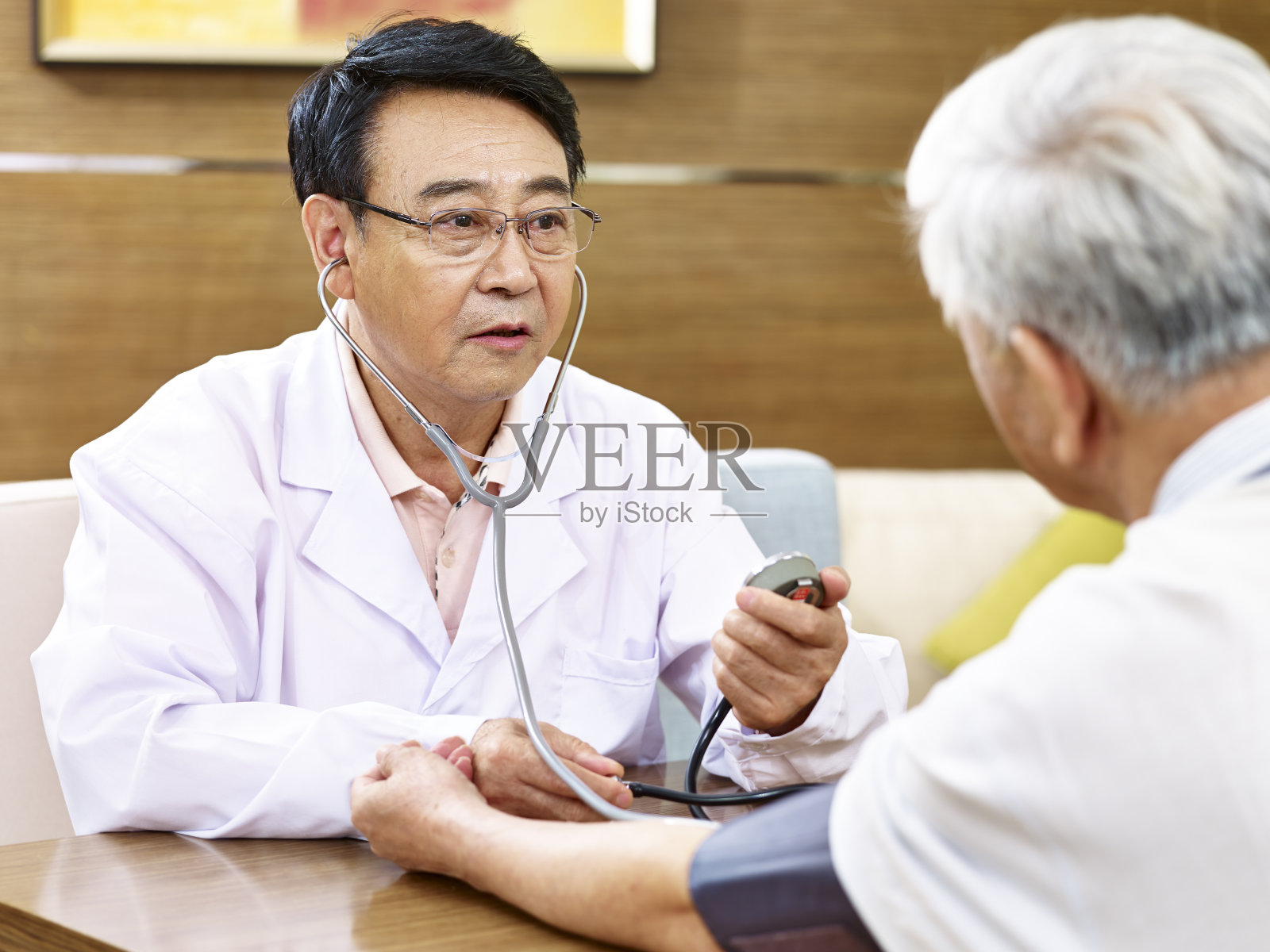 亚洲医生检查血压的一个老病人照片摄影图片
