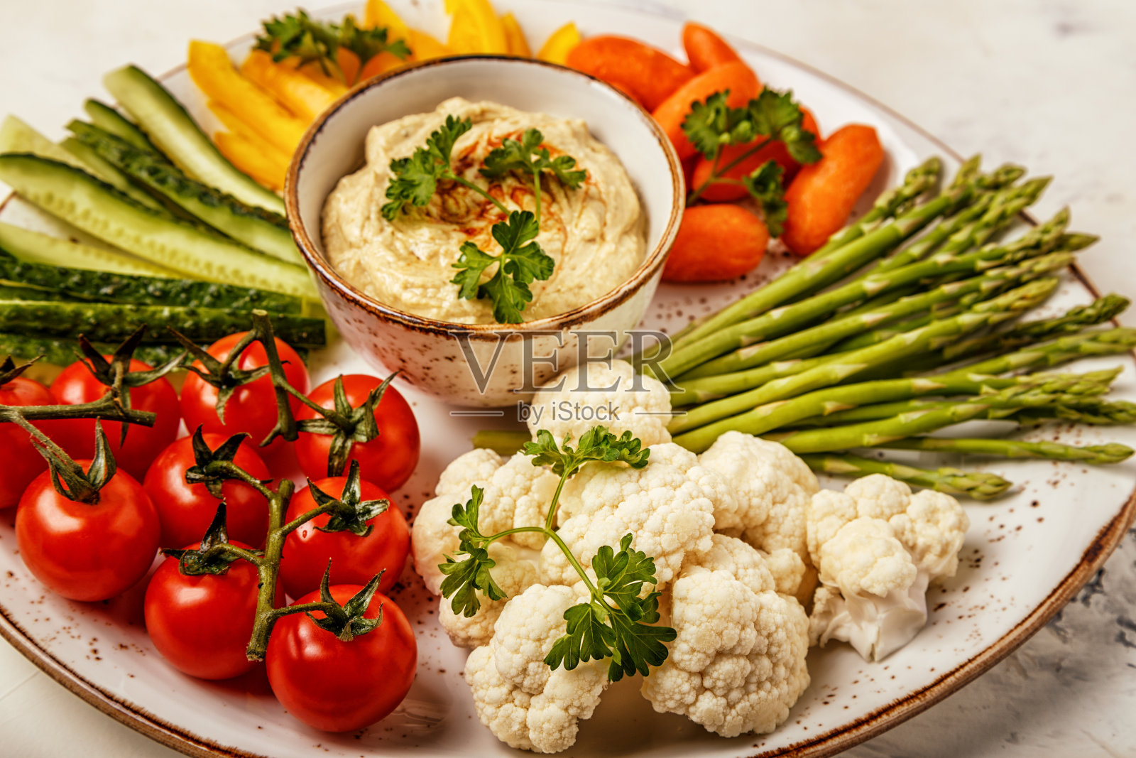 健康自制鹰嘴豆泥配各种新鲜蔬菜。照片摄影图片