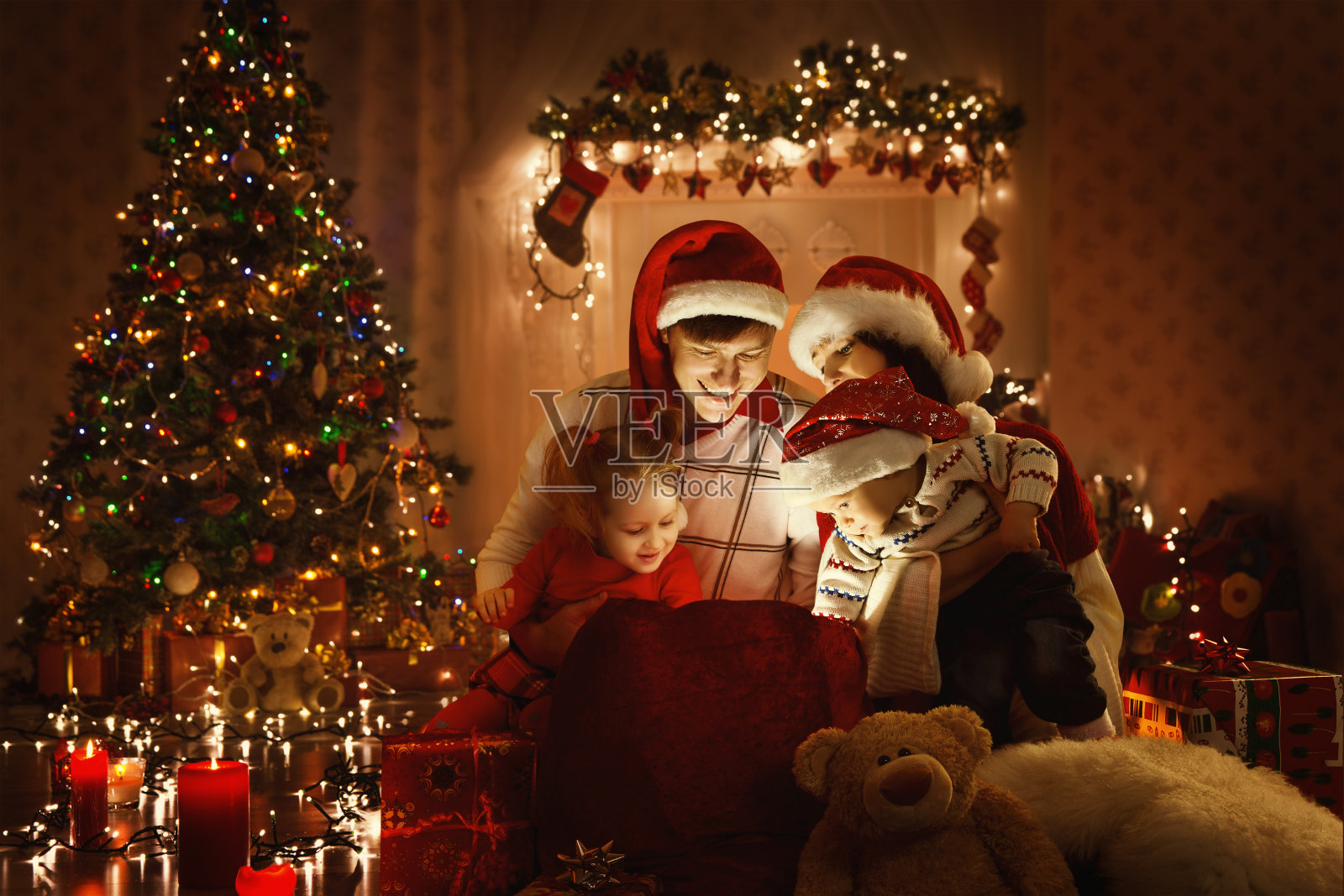 圣诞家庭打开礼物袋，看灯，圣诞树照片摄影图片
