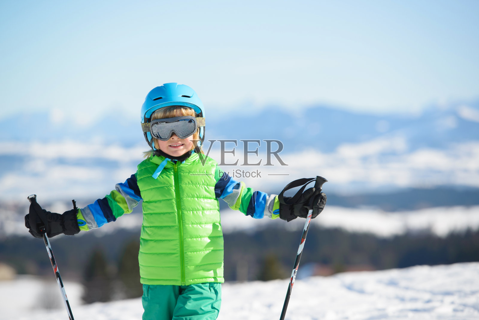微笑的滑雪男孩在山上玩得很开心照片摄影图片