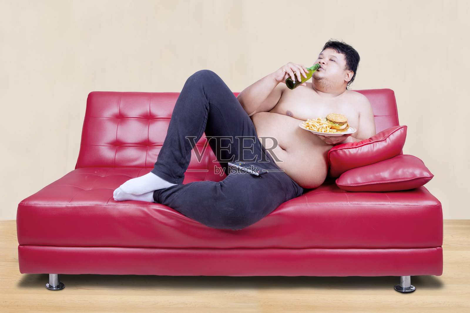 倚在沙发上的超重男子照片摄影图片