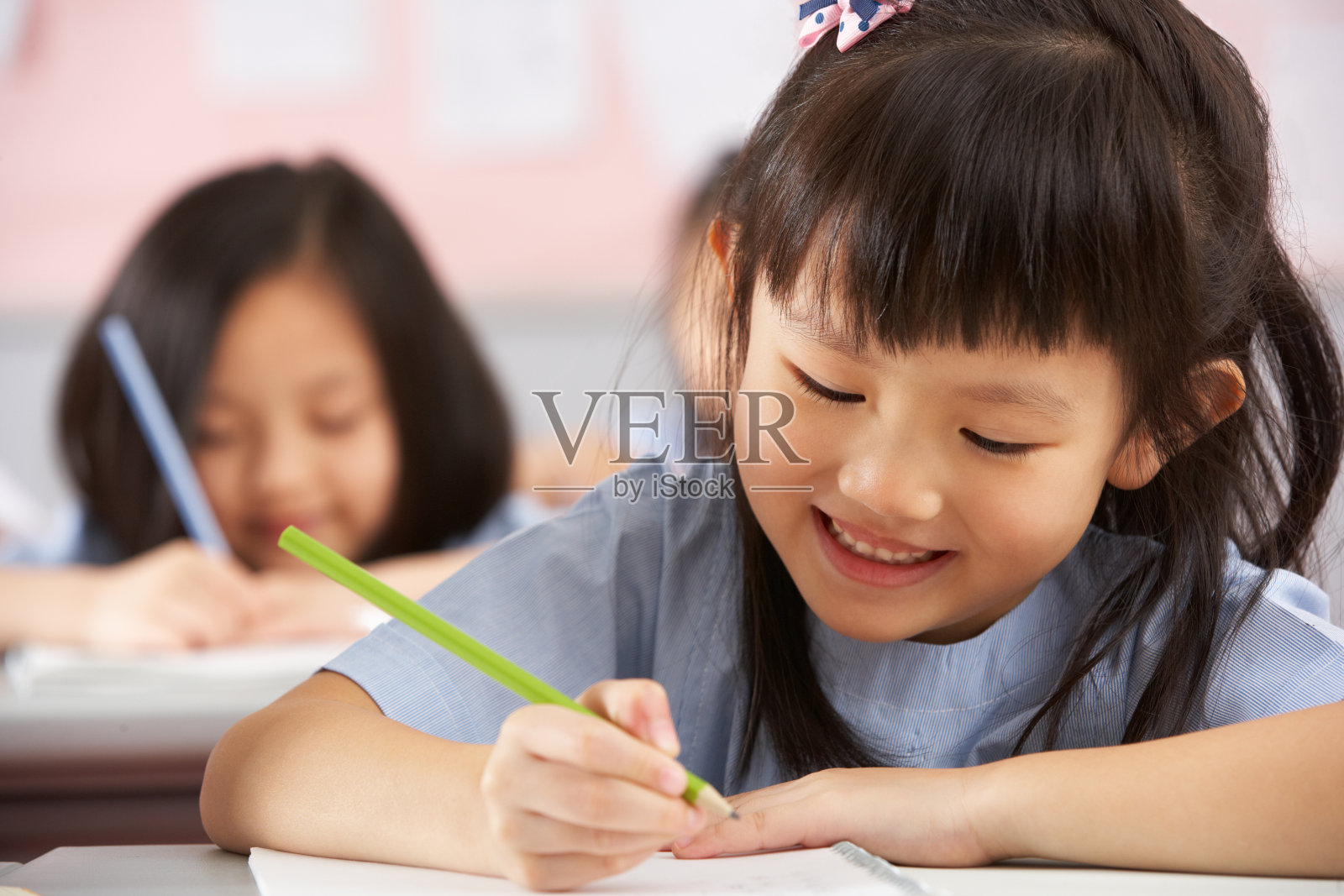 中国孩子在教室的课桌上工作照片摄影图片