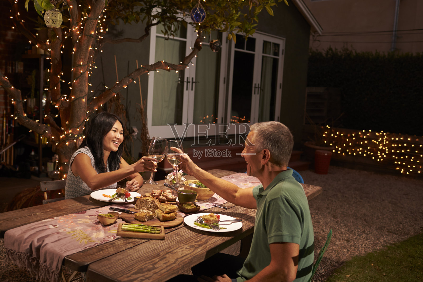 在后院享受户外大餐的成熟夫妇照片摄影图片