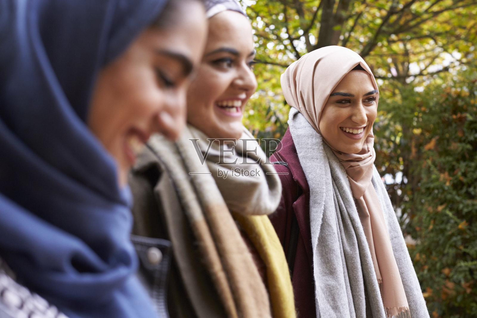 英国穆斯林女性朋友在城市环境中聚会照片摄影图片