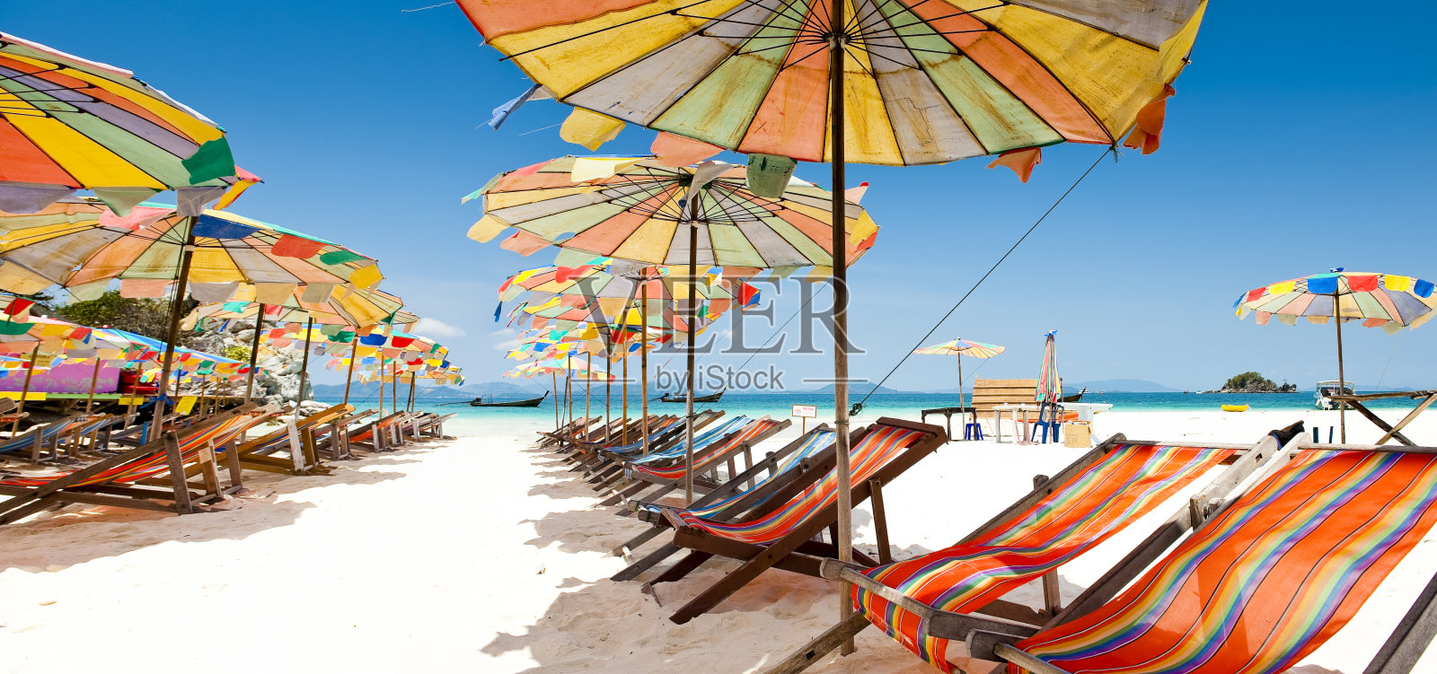 沙滩上五颜六色的遮阳伞和椅子照片摄影图片