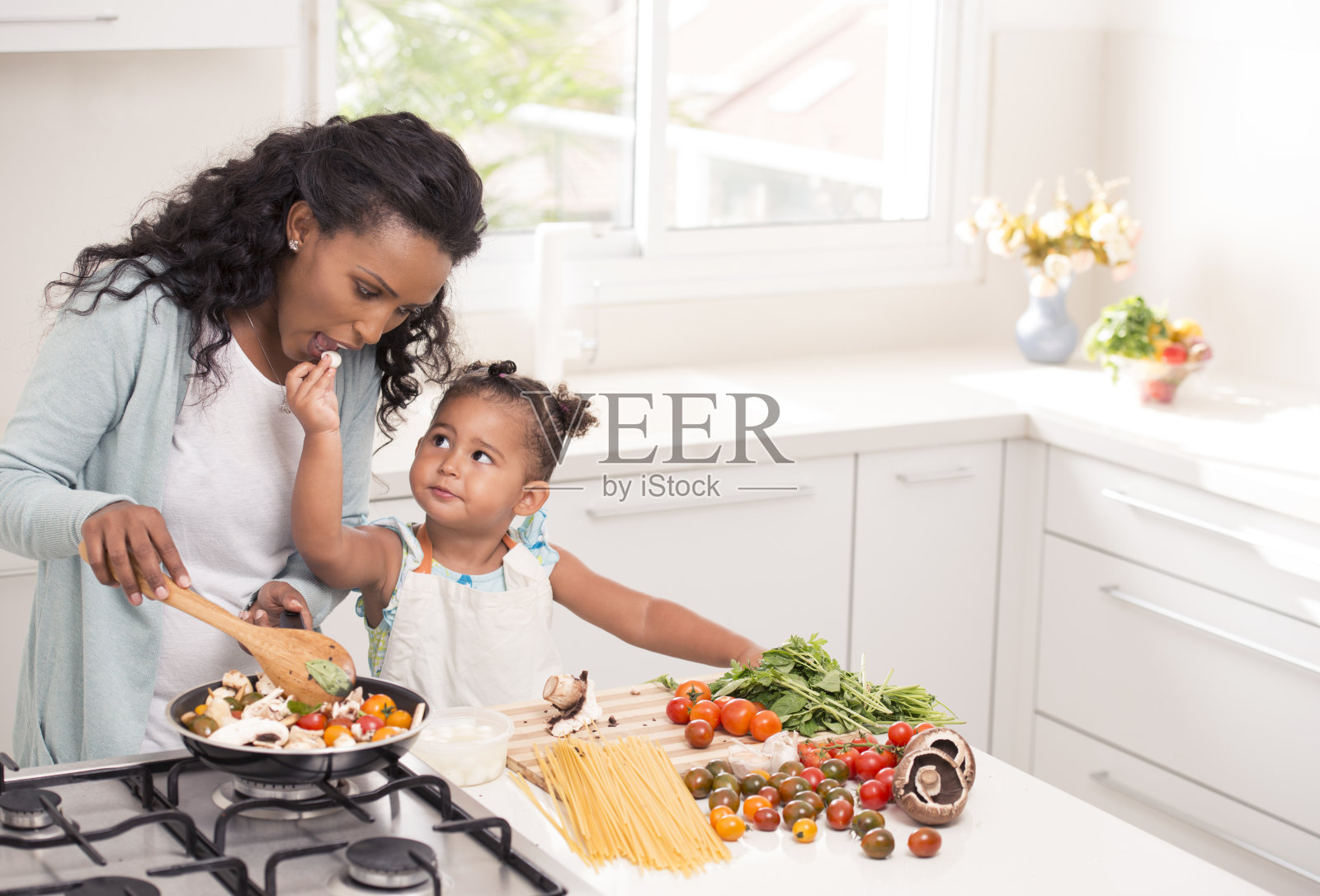 母亲和女儿一起做饭。照片摄影图片