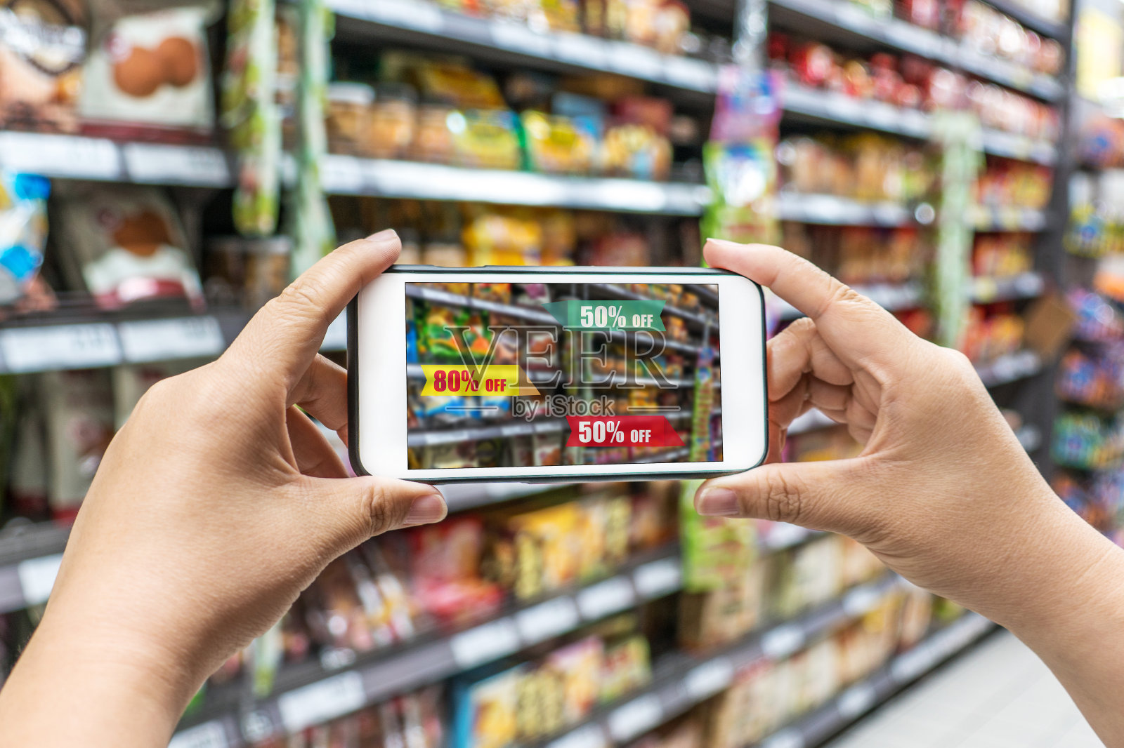 一名手持智能手机，使用增强现实技术的男子在超市买了一些食物照片摄影图片