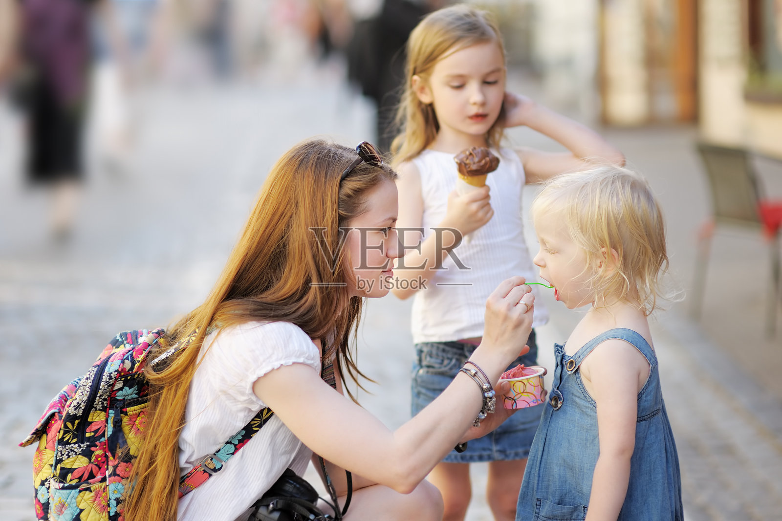 母亲和她的女儿在吃冰淇淋照片摄影图片