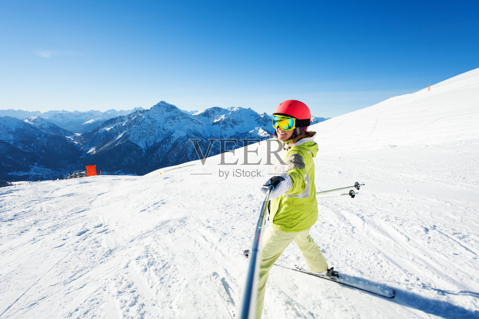 快乐的女性滑雪者使用棍棒自拍照片照片摄影图片
