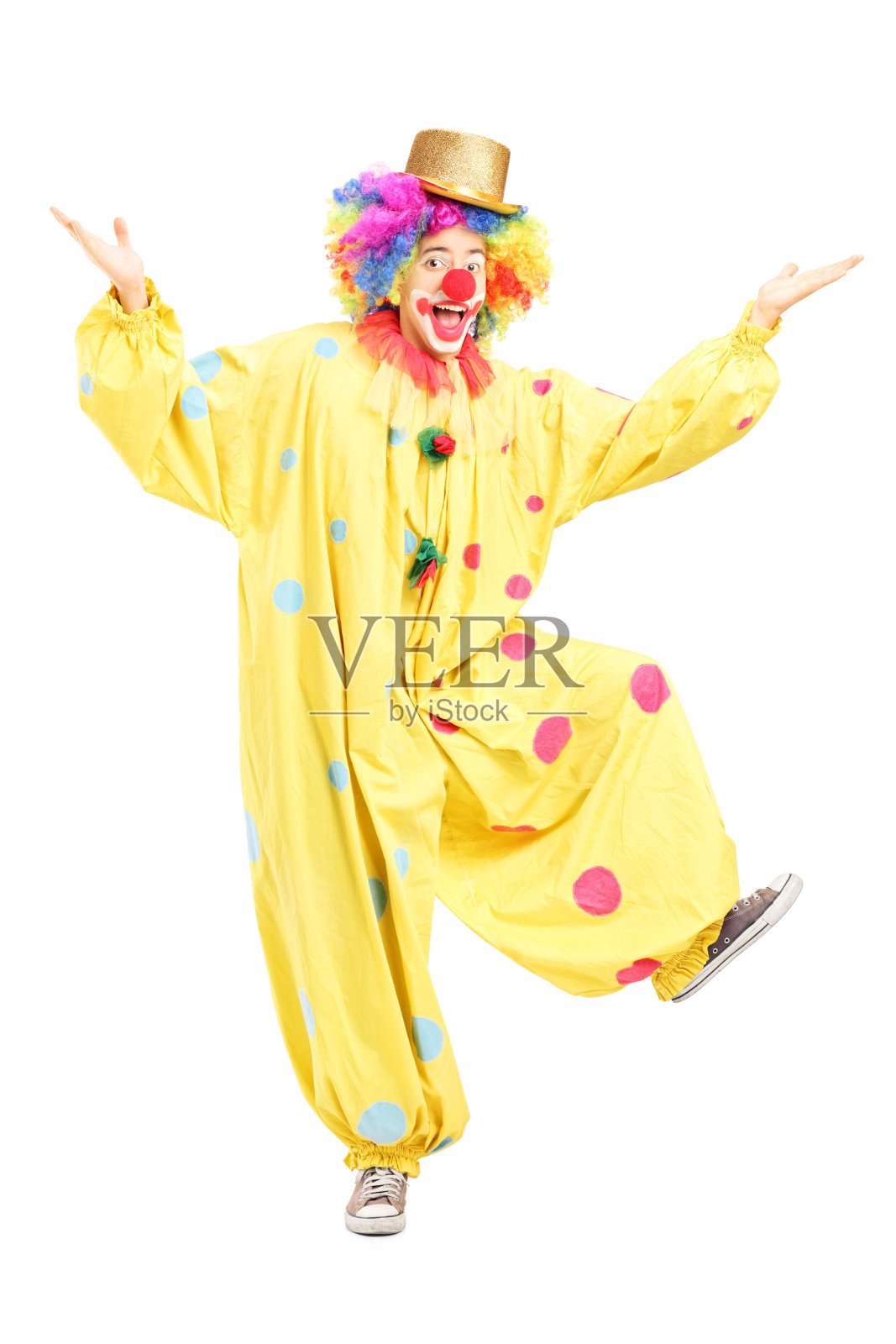 一个男性滑稽的马戏团小丑摆姿势的全长肖像照片摄影图片