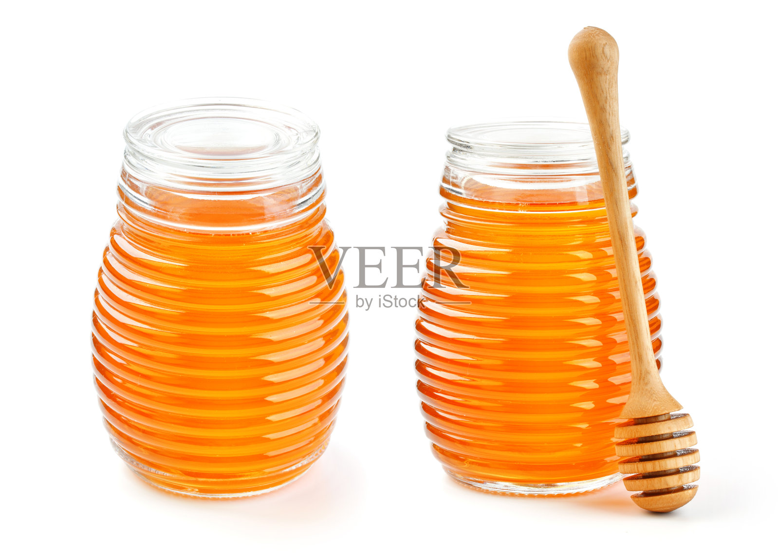 蜂蜜在玻璃罐中隔离在白色背景照片摄影图片