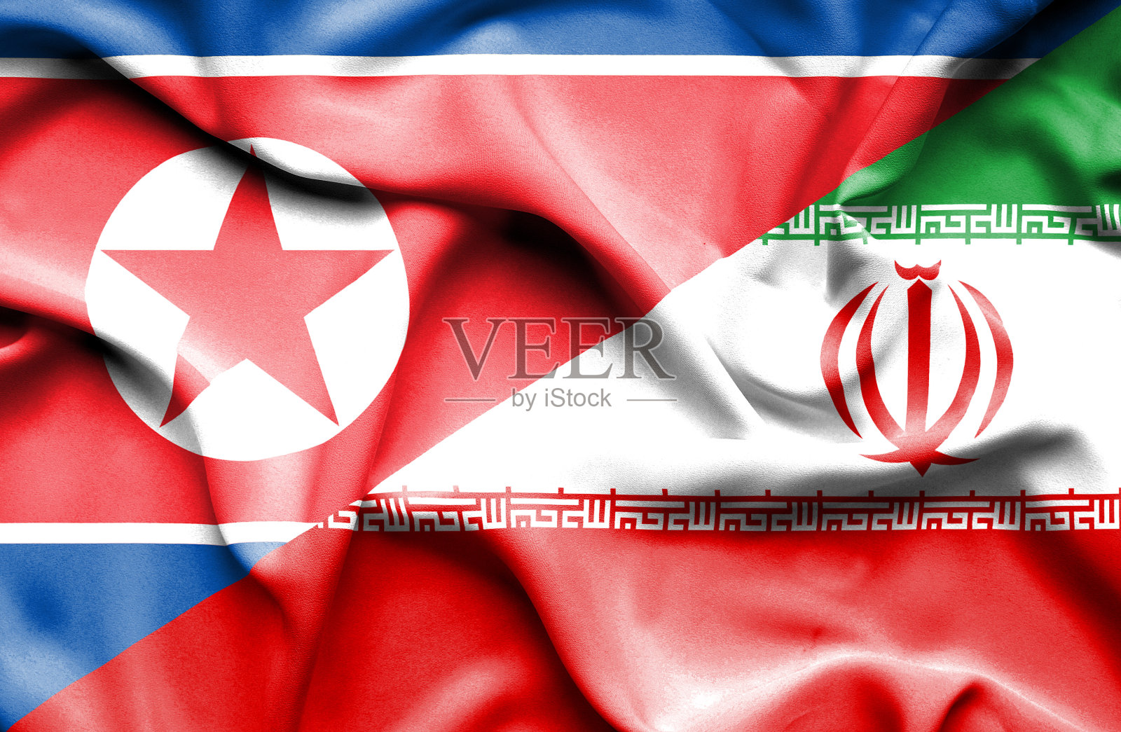 挥舞着伊朗和朝鲜的旗帜照片摄影图片