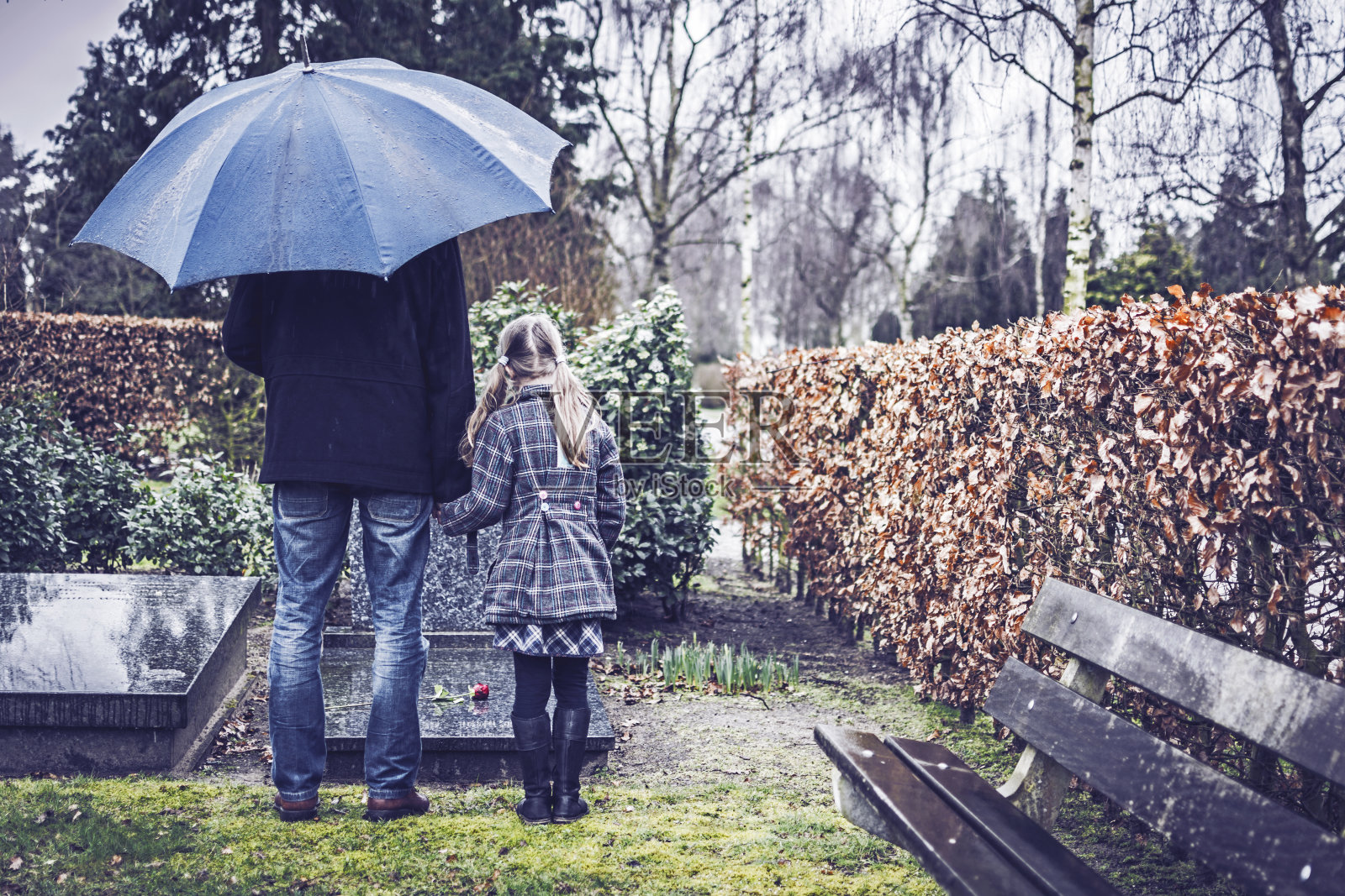 父亲和女儿拜访已故母亲的墓碑照片摄影图片