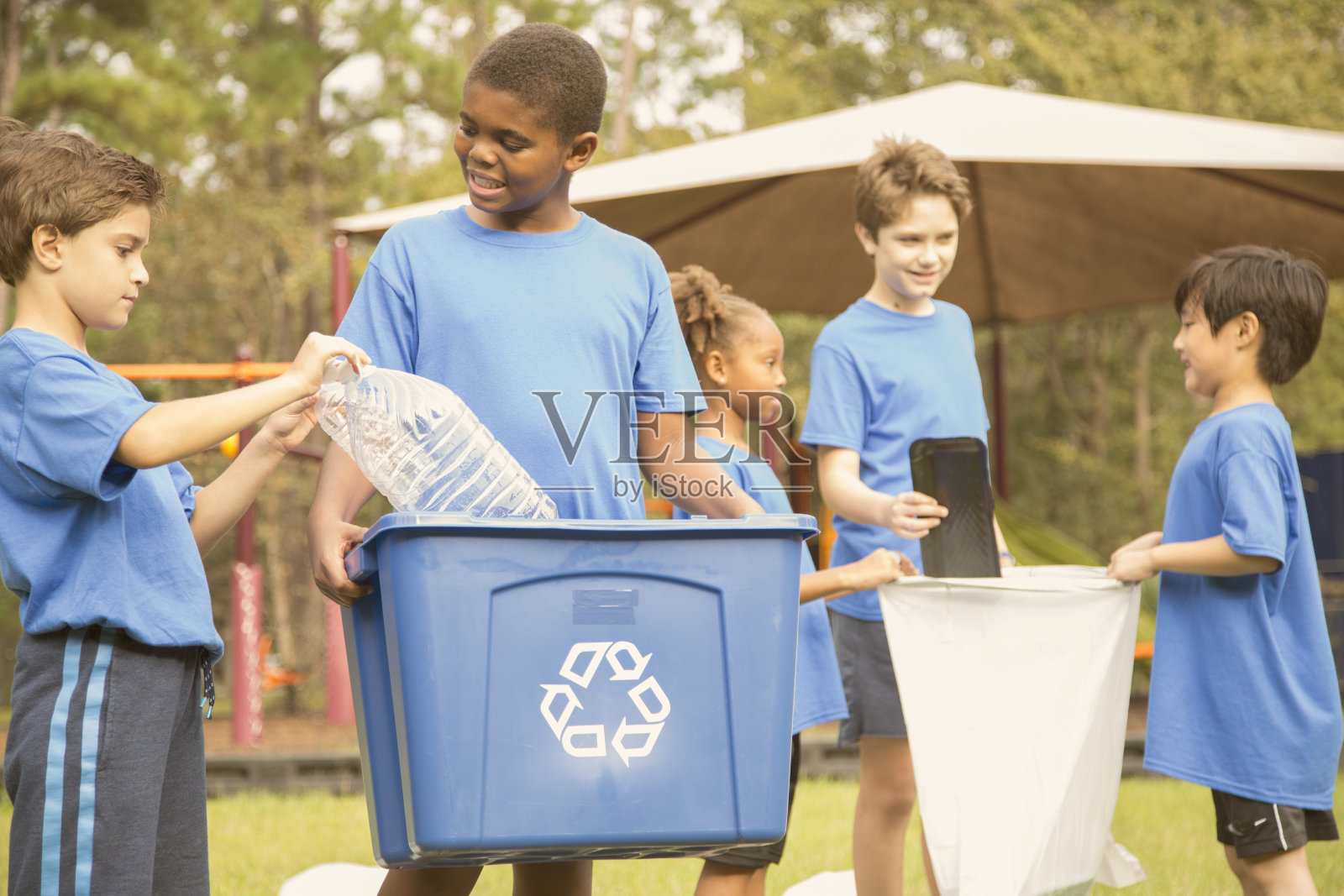 多民族学校的孩子在公园回收。照片摄影图片