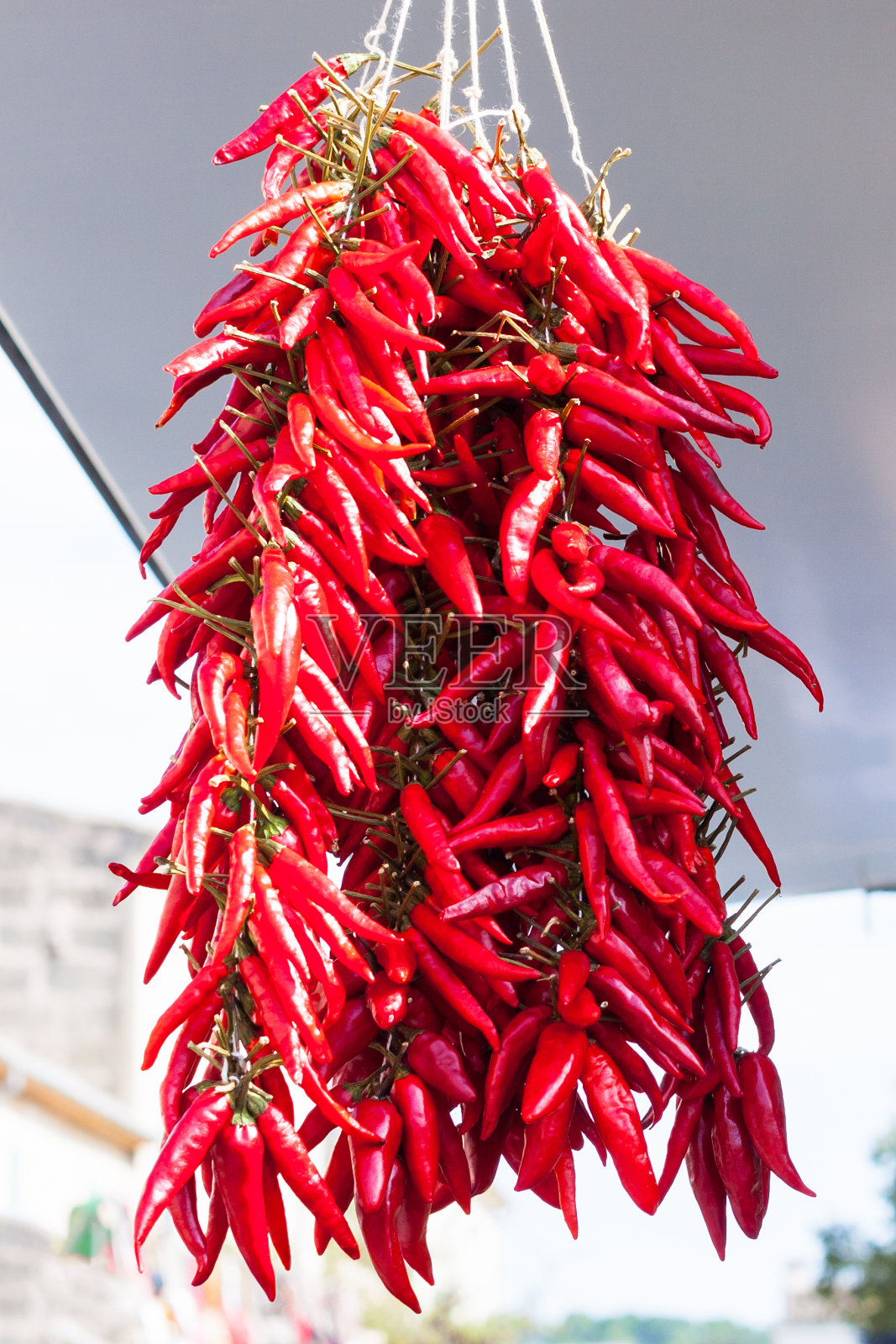 在西班牙马略卡岛的Sineu市场上，挂着一串红辣椒出售照片摄影图片