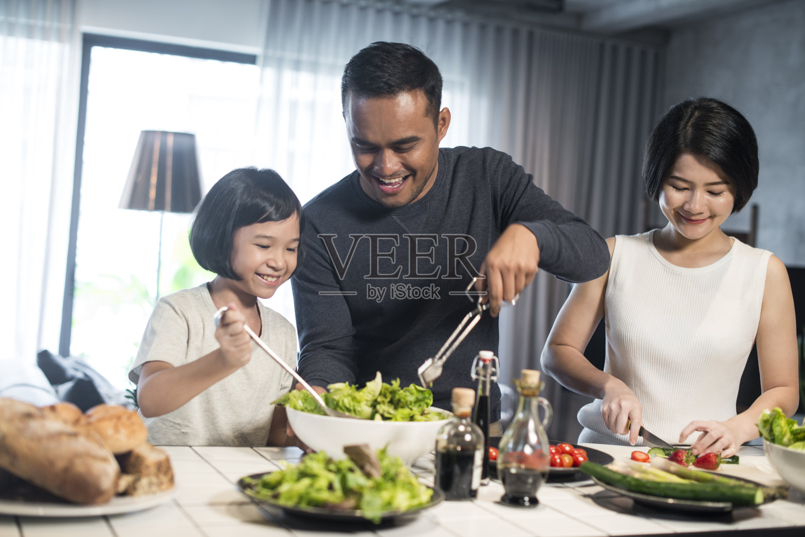 亚洲家庭在家做饭。照片摄影图片