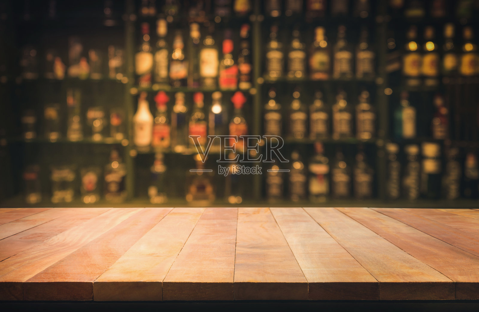 木质桌子与模糊的柜台酒吧和瓶子背景照片摄影图片