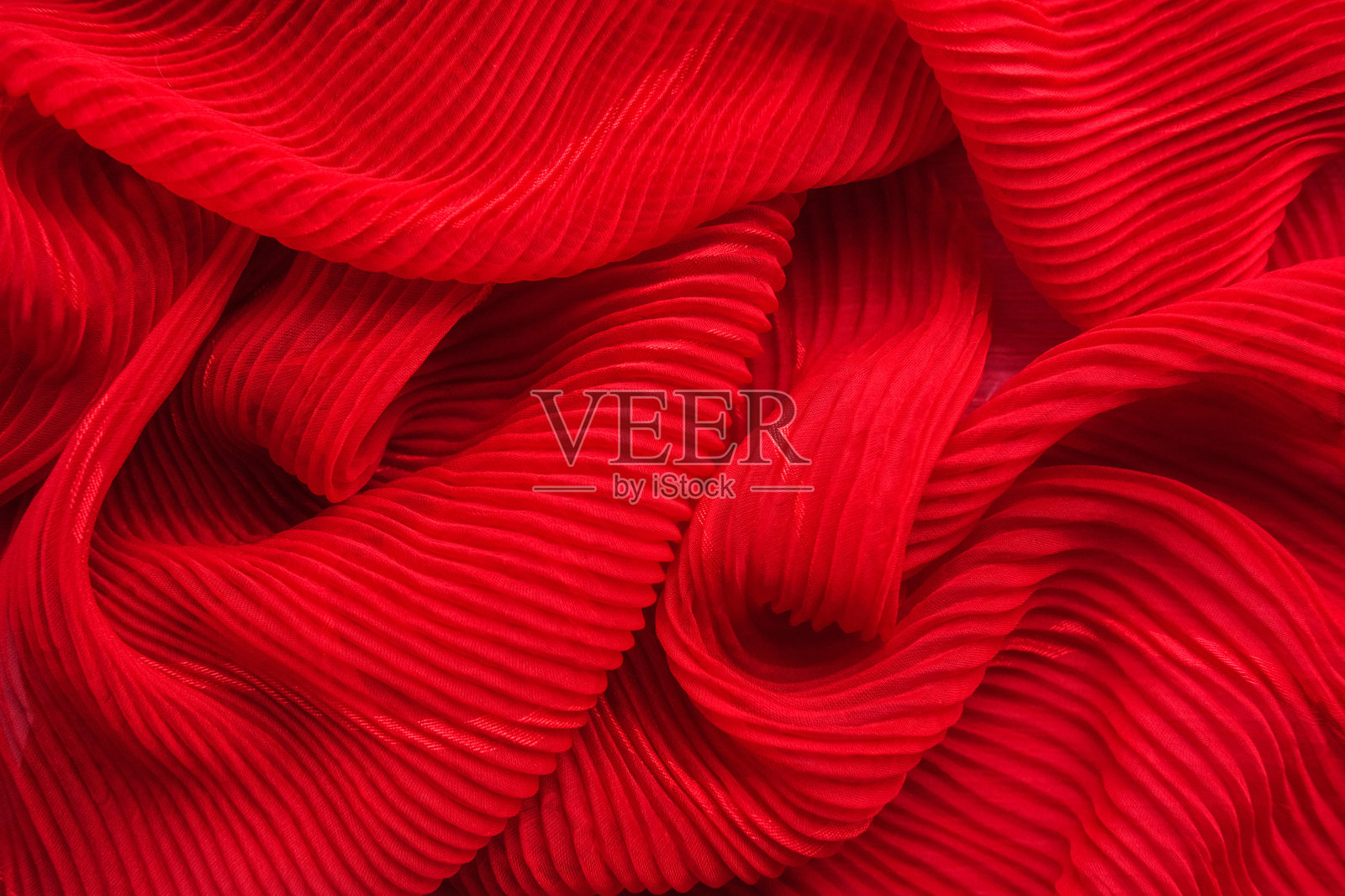 压花面料,褶皱。红色的纺织材料。照片摄影图片