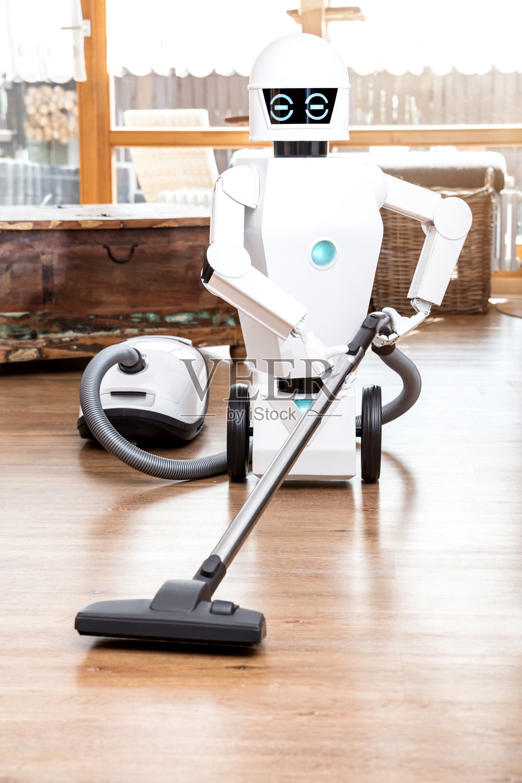 环境辅助机器人正在用吸尘器清扫客厅的地板照片摄影图片