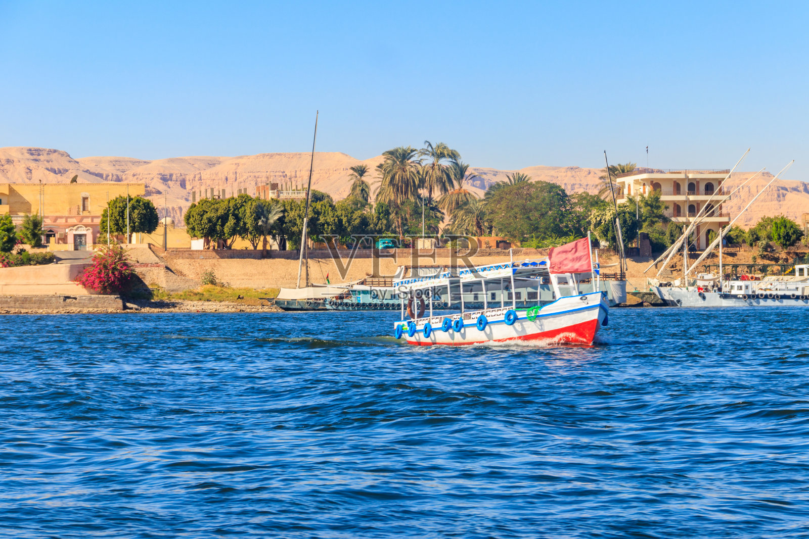 一艘游船在埃及卢克索的尼罗河上航行照片摄影图片