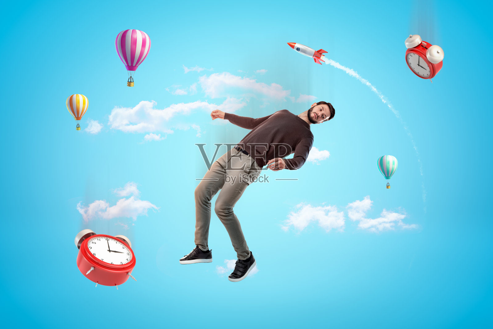 一个年轻人和两个闹钟漂浮在蓝天上，背景是火箭和热气球。照片摄影图片