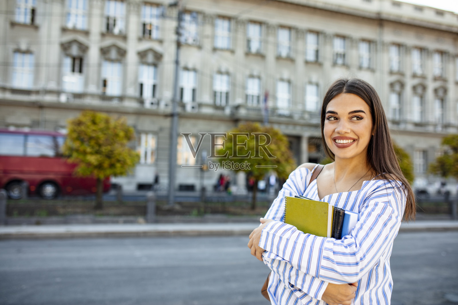 一个微笑的女大学生站在校园里的肖像照片摄影图片