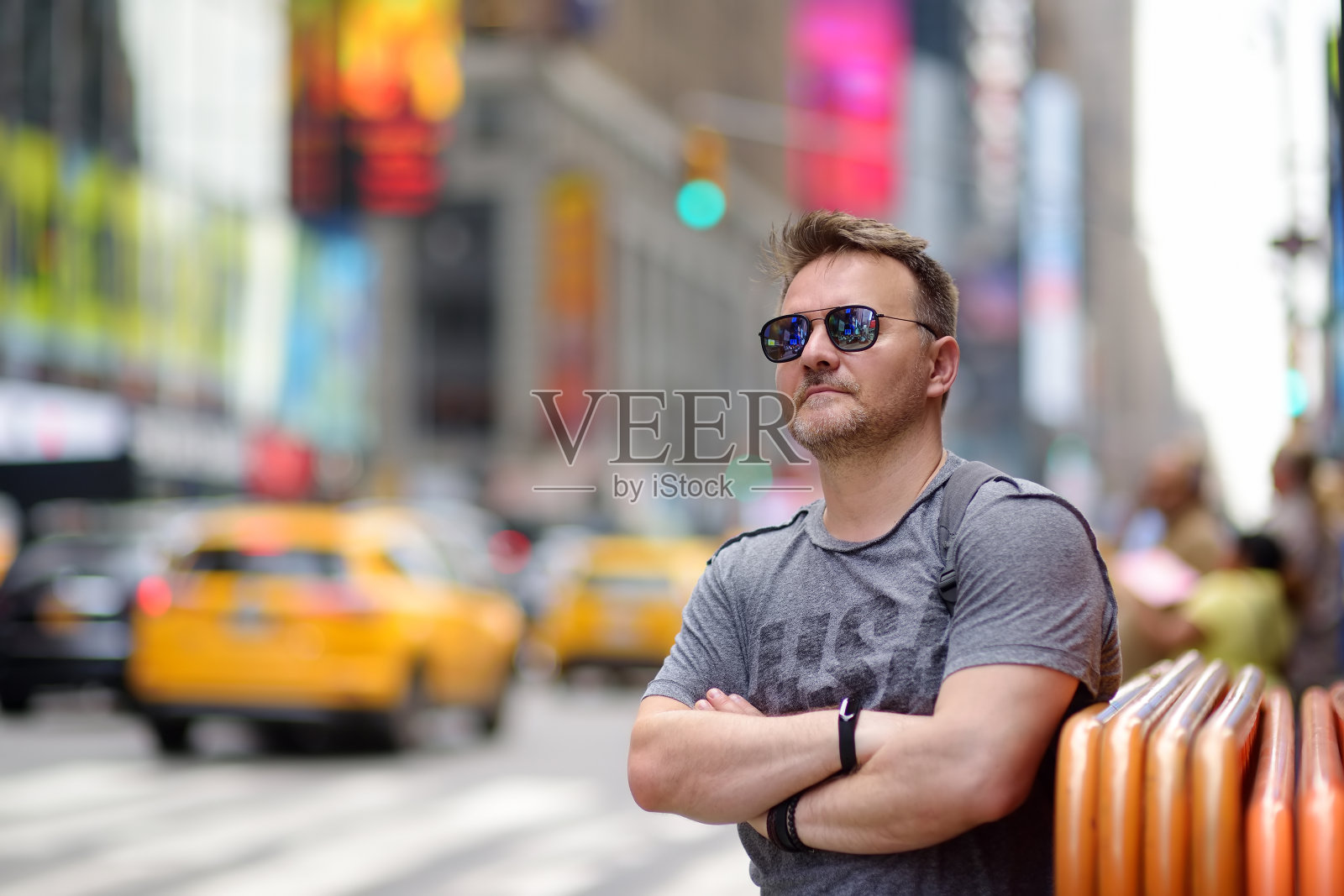 一个阳光明媚的夏日，中年男子在纽约曼哈顿市中心的时代广场上观看。照片摄影图片
