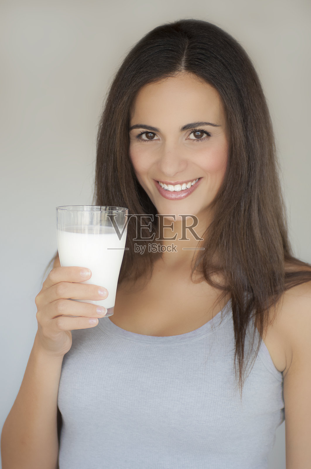 一个美丽微笑的女人喝一杯牛奶的肖像照片摄影图片