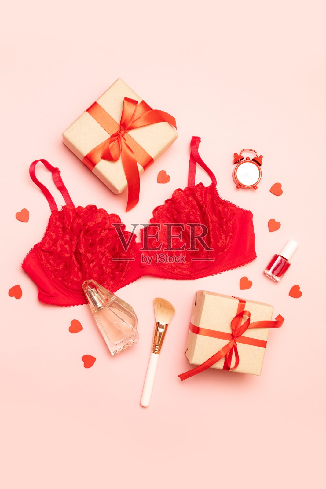 红色蕾丝胸罩，香水，礼品盒和化妆品刷在粉红色的背景创造性的组成照片摄影图片