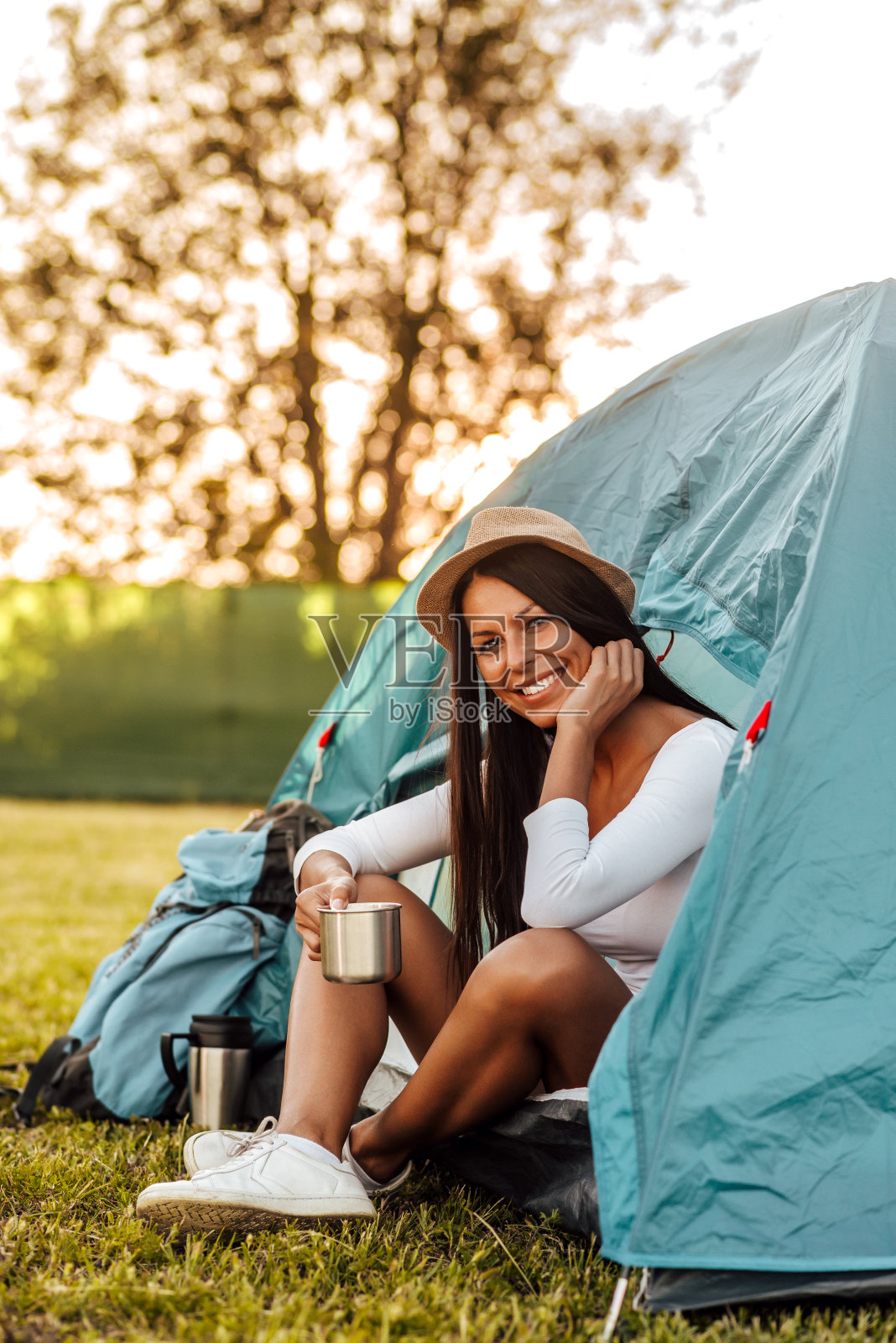 一个快乐的女人在假期露营的肖像。照片摄影图片