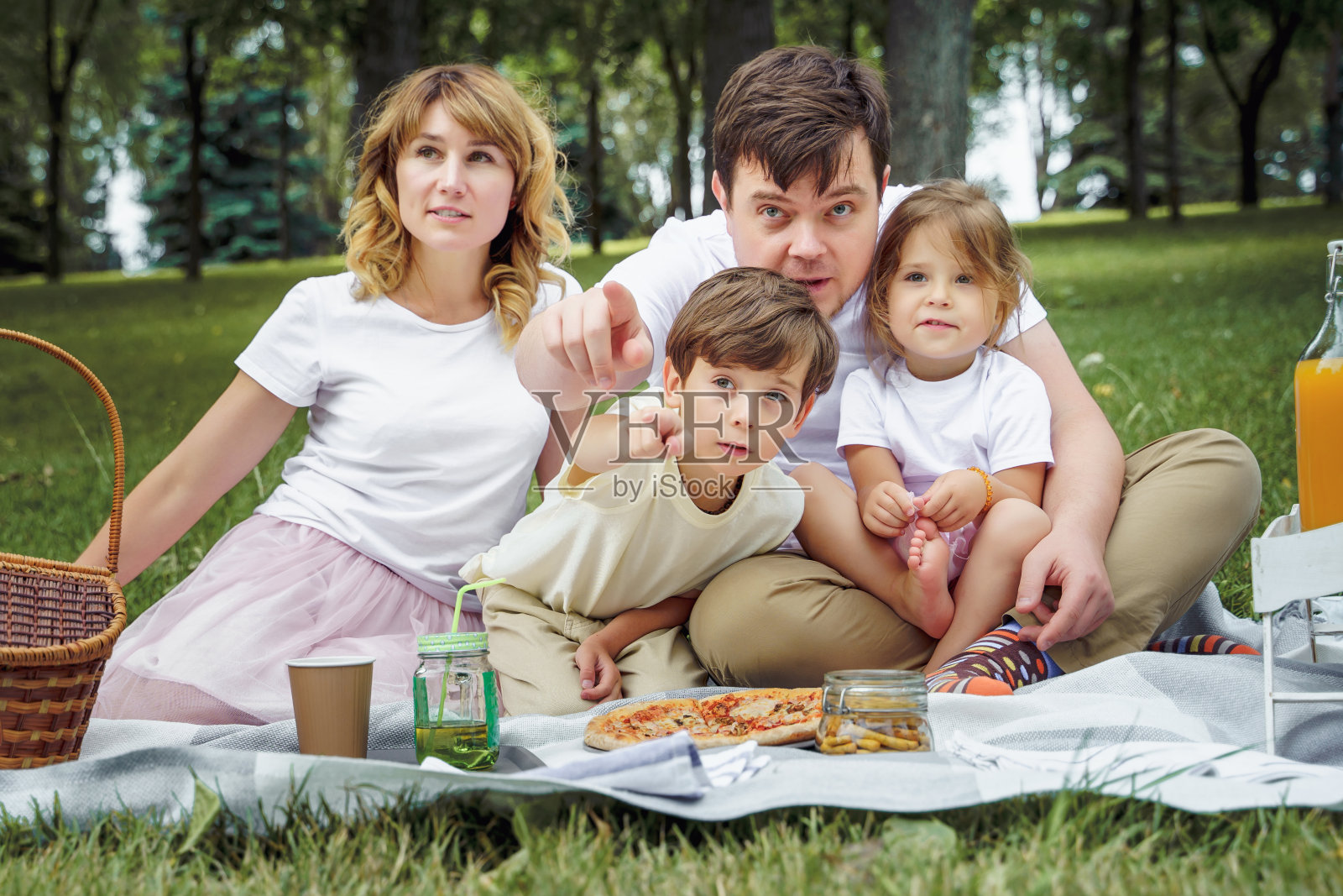一个阳光明媚的夏日，一个快乐的家庭在野餐照片摄影图片