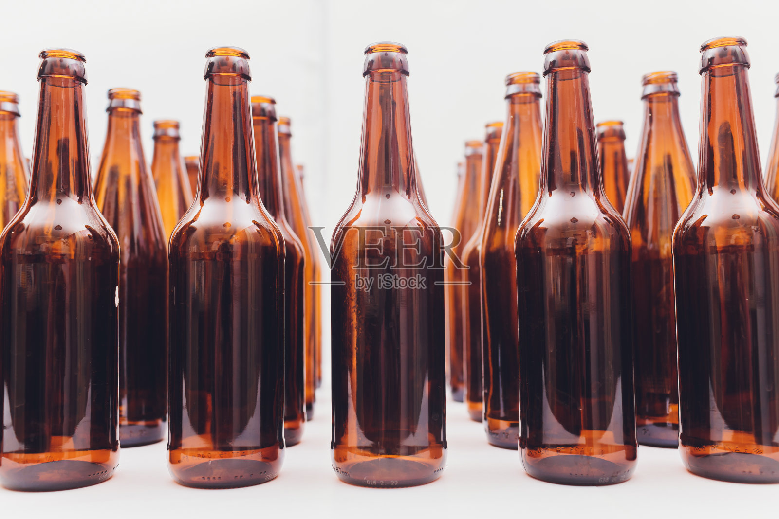啤酒瓶的特写，集中在中间的一个，孤立的白色背景。照片摄影图片