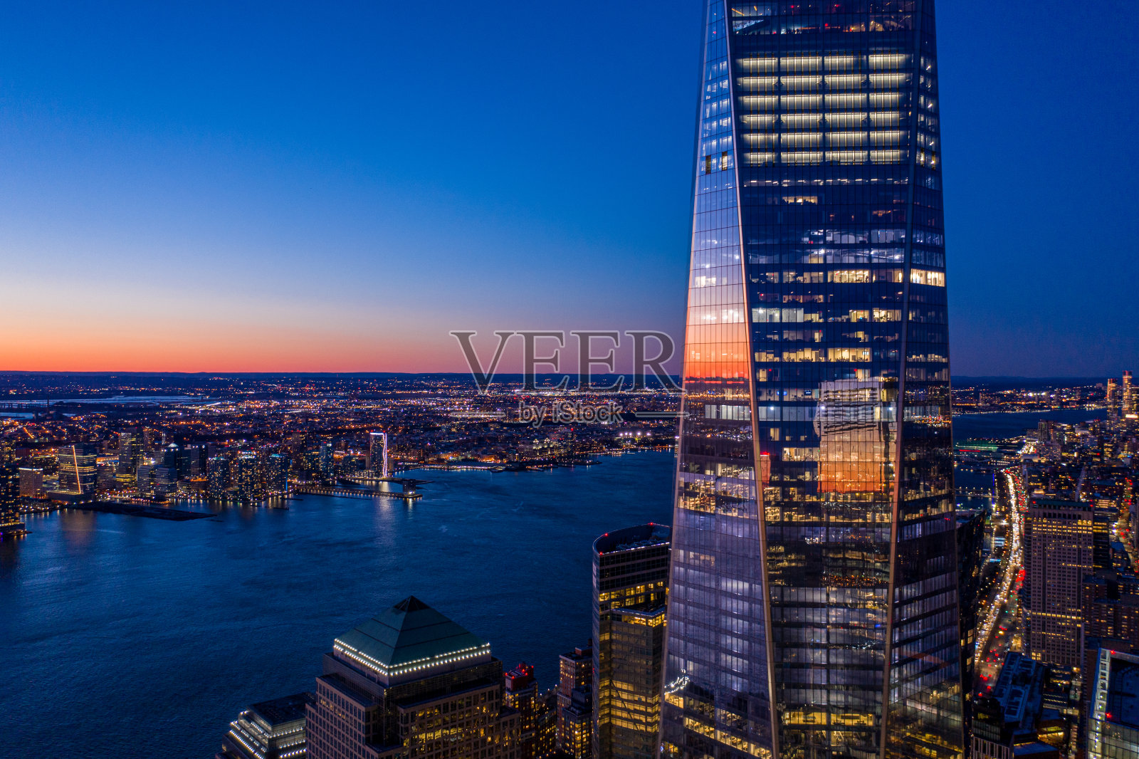 黄昏时分，世界贸易中心一号大楼俯瞰纽约市曼哈顿的天际线。照片摄影图片