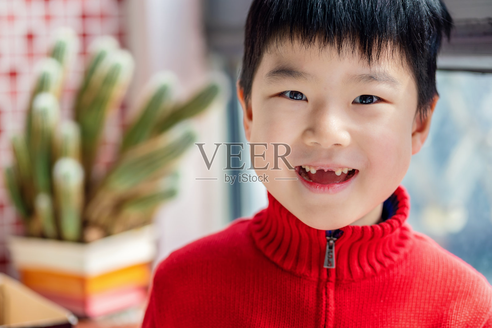 亚洲可爱的男孩显示缺门牙照片摄影图片