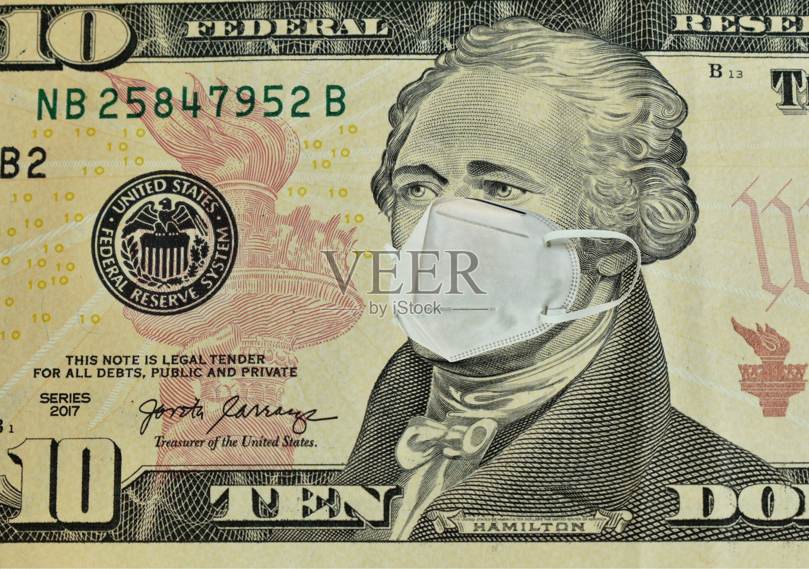 卫生口罩将亚历山大·汉密尔顿先生的脸印在十元白底美钞上照片摄影图片