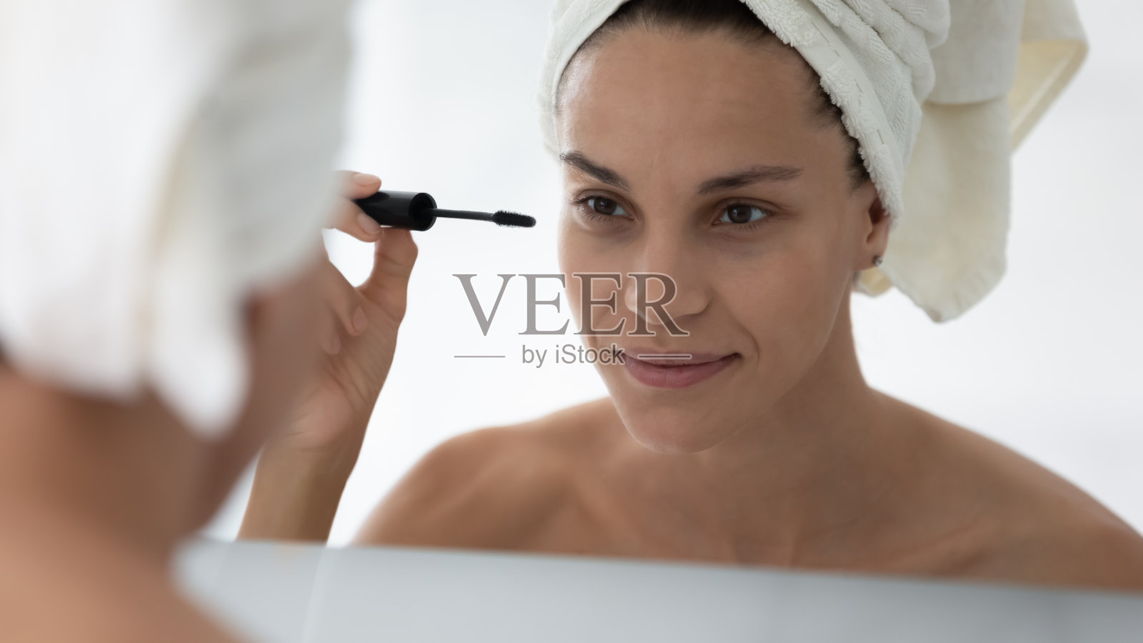 女人拿着管用黑色睫毛膏在睫毛上的特写图像照片摄影图片