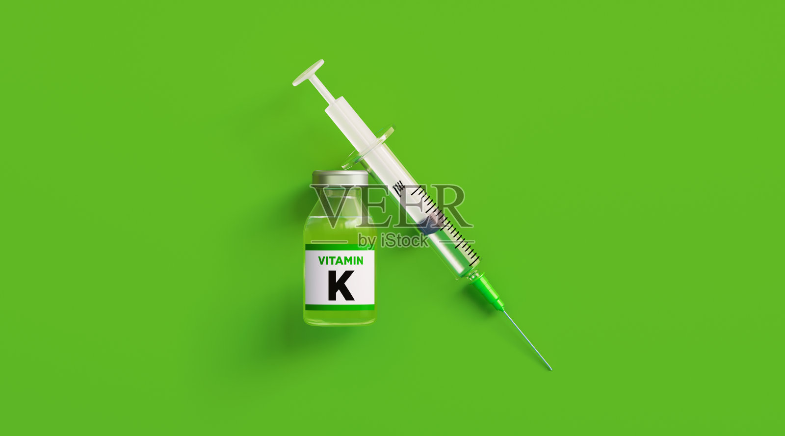 绿色背景下的注射用维生素K和注射器照片摄影图片