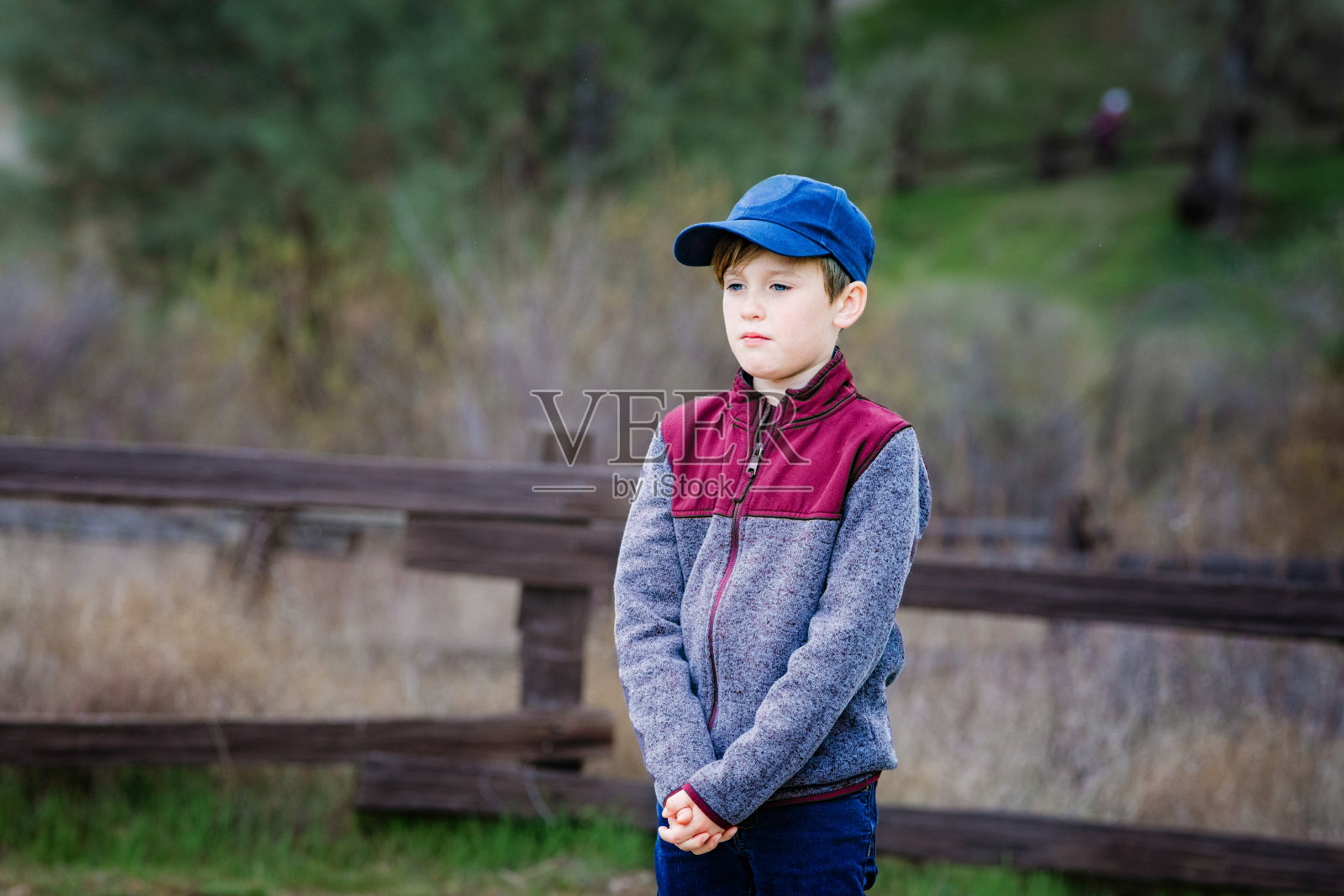 失望的男孩站在大自然中，一脸的悲伤照片摄影图片