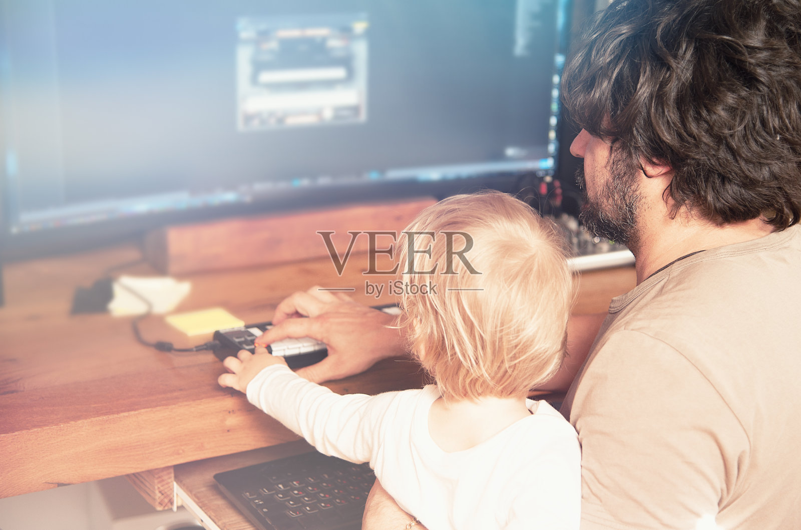 父亲和儿子在PC上玩虚拟钢琴照片摄影图片