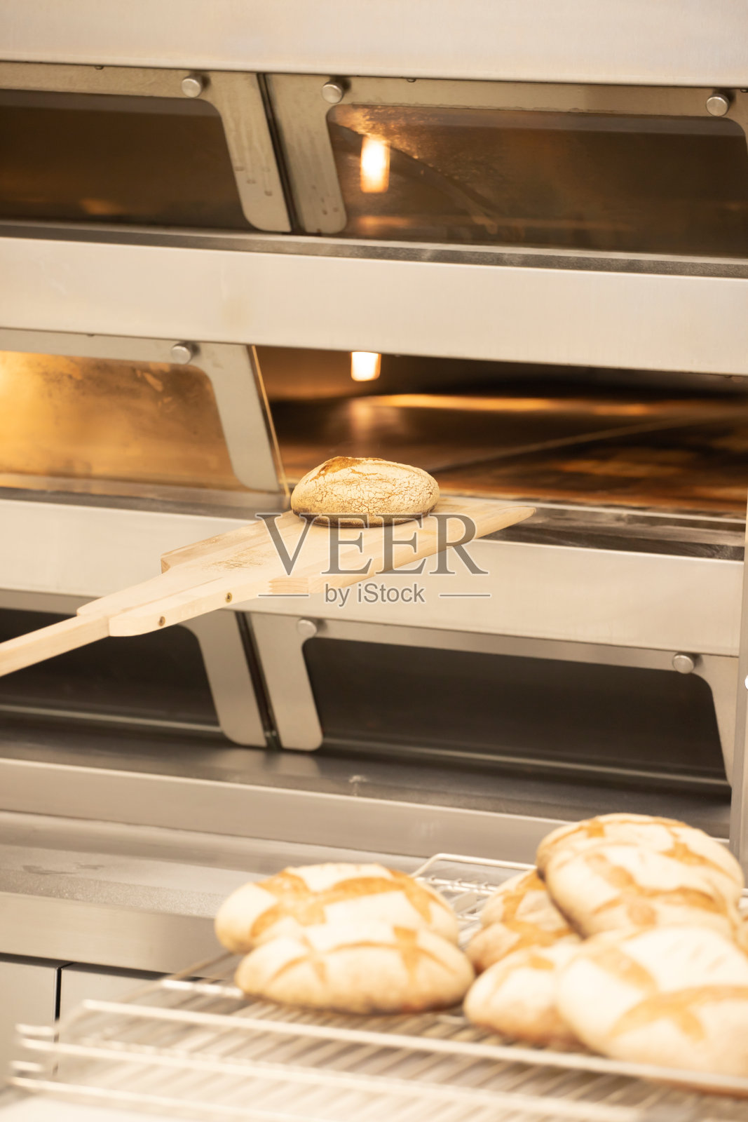 在面包店用烤箱烤面包。照片摄影图片