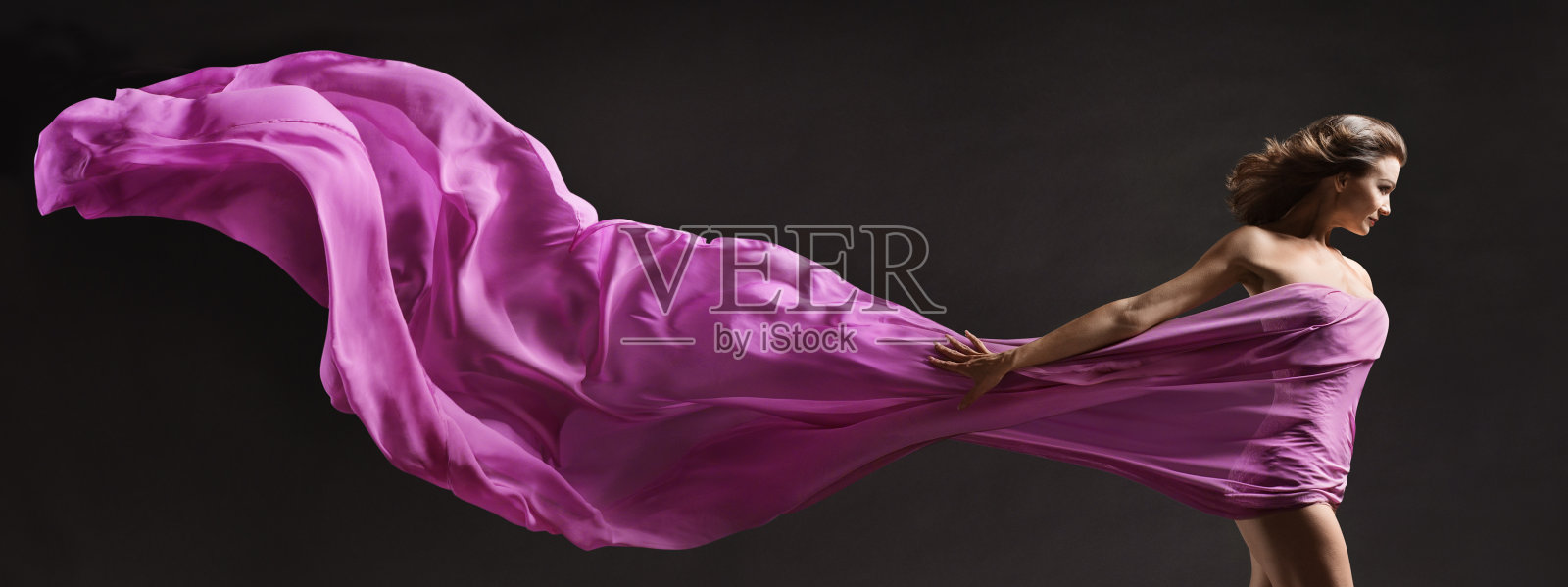 女人跳舞。现代芭蕾舞者与长织物旗帜在空中飞扬。副本的空间。黑色背景照片摄影图片