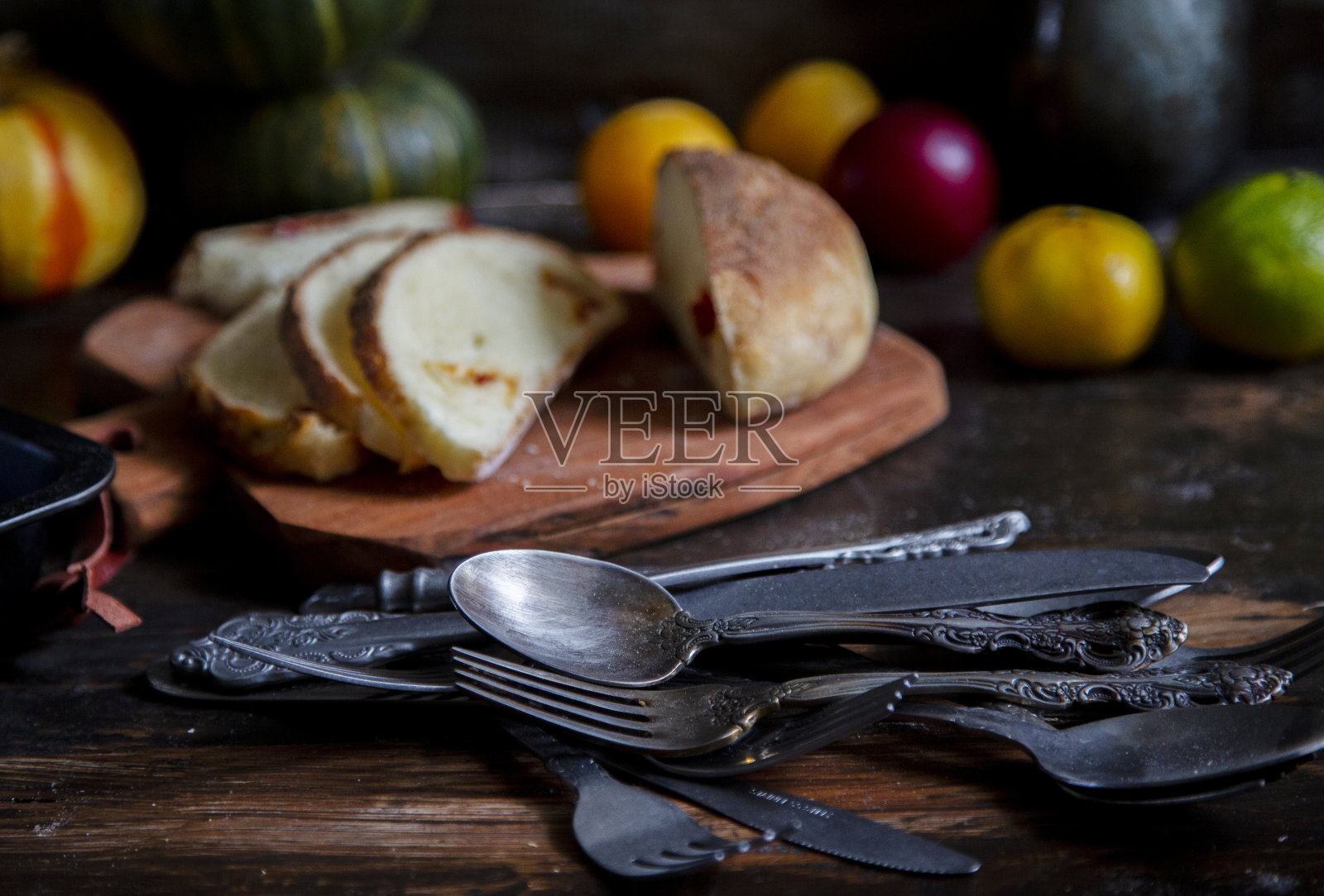 面包，水果和各种勺子在家庭餐桌上照片摄影图片