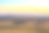 蒙大拿州的自然风景-在日落时分，牛在长满青草的山丘上吃草素材图片